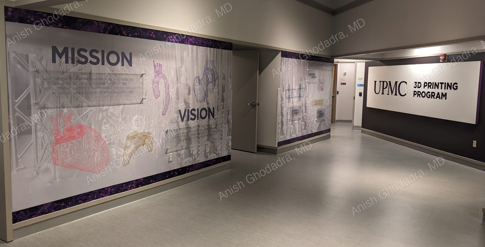 The UPMC 3D Printing Program facility, with a wall displaying the program's mission and vision and 3D-printed anatomic renderings